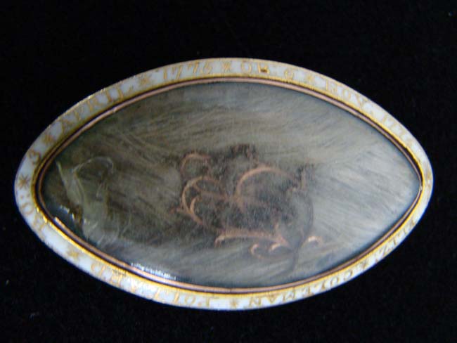 A 1776 Dated and Inscribed   Gold Memorial Pinback Broach with encased lock of  hair belonging to Elizabeth Coleman Pollard who died at the age of one.